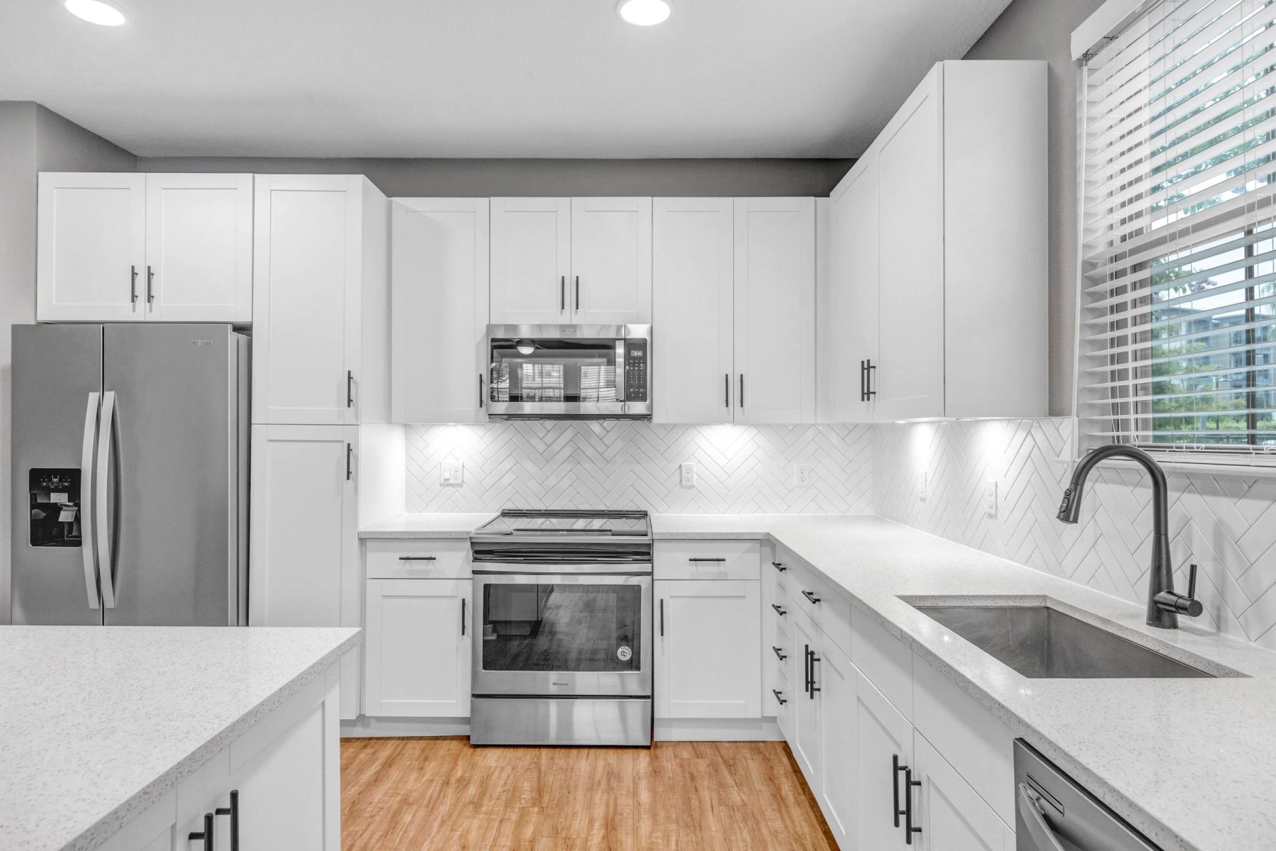 Luxury apartment kitchen with stainless steel appliances, granite countertops, and lots of storage space